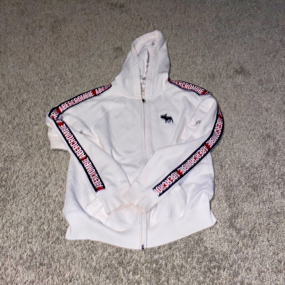 white zip white hoodie with brand name on sleeve